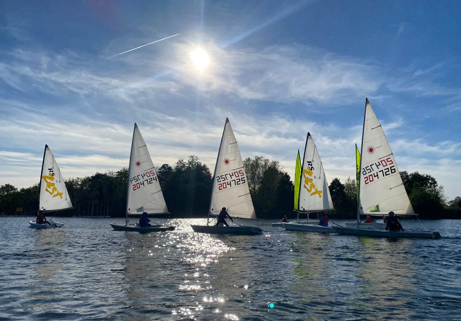 Two young sailors rounding a buoy in dinghies