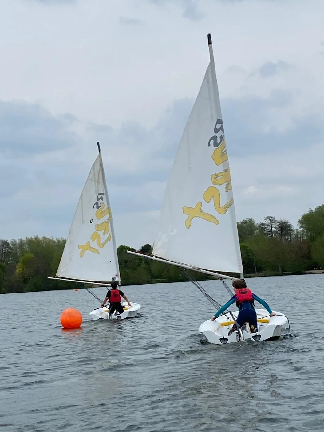 Dinghies sailing on the lake in bright sun